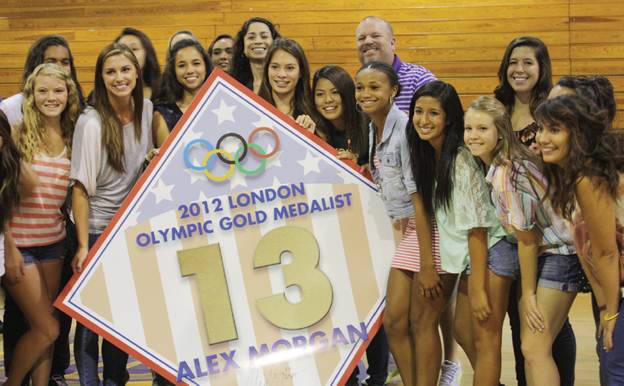 LUCKY NUMBER 13(Second to the left, front) - Alex Morgan proudly displays her diamond banner with the current girls soccer team and faculty members to celebrate her retired number.