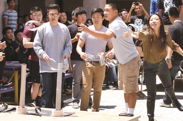 THROW IN A CHANGE - Students participate in a lunch time activity at the APES rally, Put a Cell on It, on May 10.