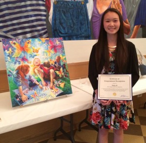 Shi poses next to her painting, "Flying with Hope". She is the grand prize winner for the Congressional Art Competition for her district.