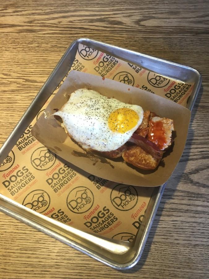 Dog Haus, located in Fullerton, offers a variety of specialty hot dogs, including the best-selling Old Town Dog (left), which consists of a bacon wrapped dog sprinkled with cheese and jalapeños,  and customer favorite, Grand Slam (right), which features a sunny side up egg, tater tots, and bacon strips.