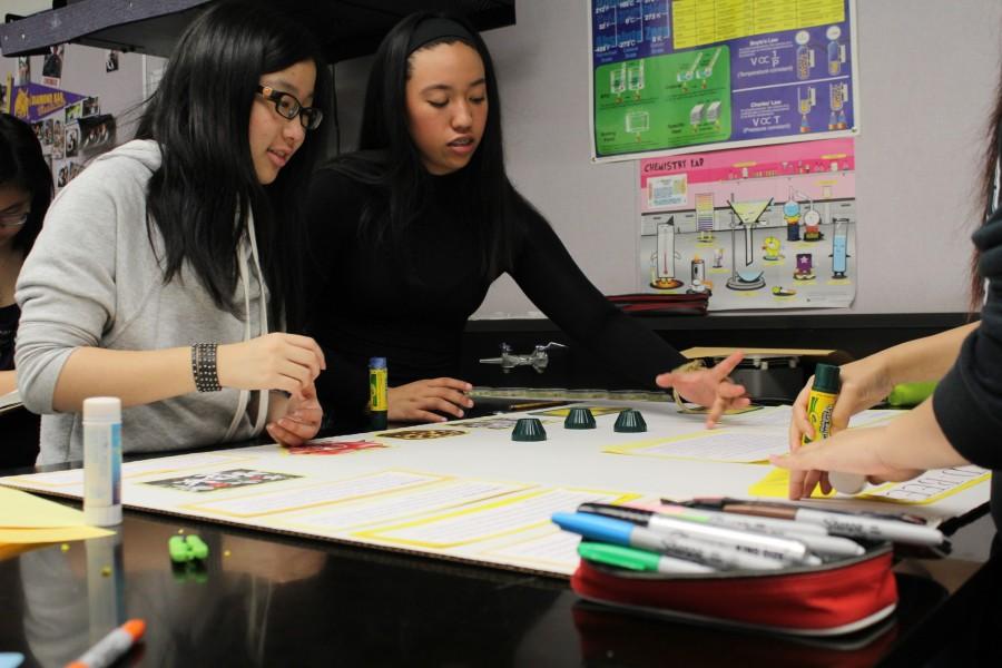 Seniors Karina Kuo (left) and Jessica Gomez work on their project, D-Bees Trees, meant to help honeybees in the area.