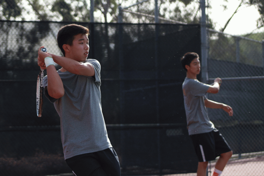Sophomore Nicholas Wong and senior Austin Chiang prepare to return their opponents’ attack during a pregame match.