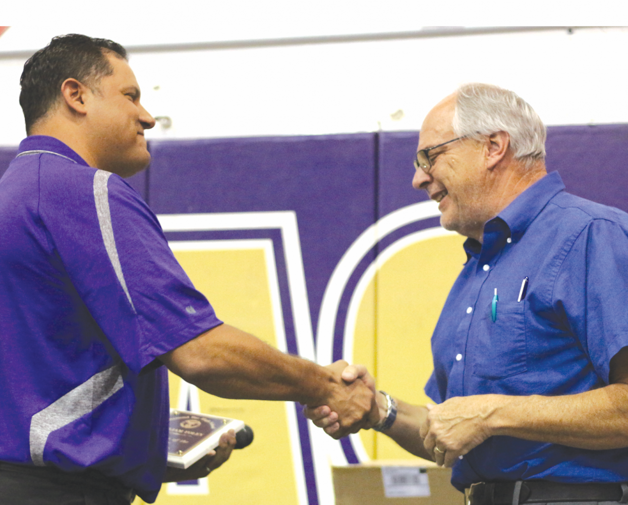 DBHS photography teacher William Foley (right) accepts the Teacher of the Year award from Principal Reuben Jones.