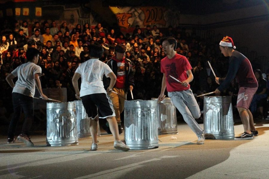 Shown left to right are senior World Line members Edison Chow, Evelyn Lee, Jack May, Isaac Kau and Hyunwoo Kim performing their percussion routine using aluminum trash cans at the winter sports rally on Dec. 8 in the gym.