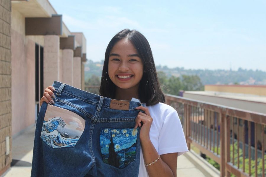 Sophmore+Julia+Ruelas+holds+up+jeans+with+her+hand-painted+designs.%0A%0A