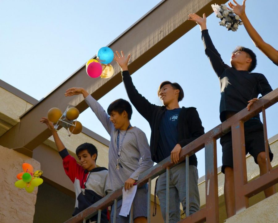 From left, AP Physics students Ernesto Perez, Joshua Park, Royce Park and Colin Park test the ability of their contraptions to protect an egg held inside