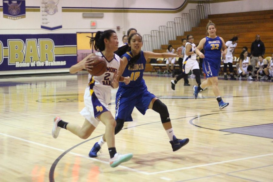 Junior Karen Shao drives to the basket during the first game of the season against Valencia. DB won the game, 56-25.

