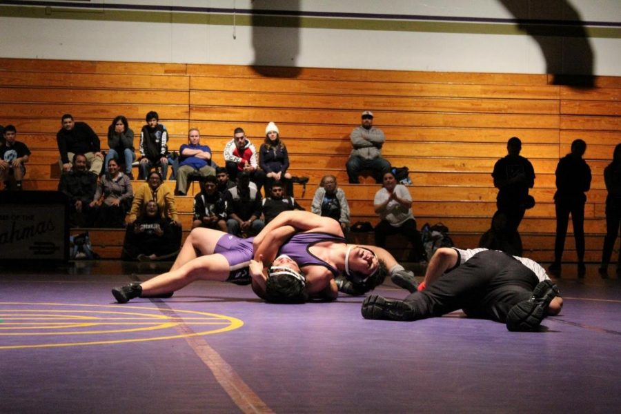 Senior Antonio Diones pins his opponent during the last match of the season.