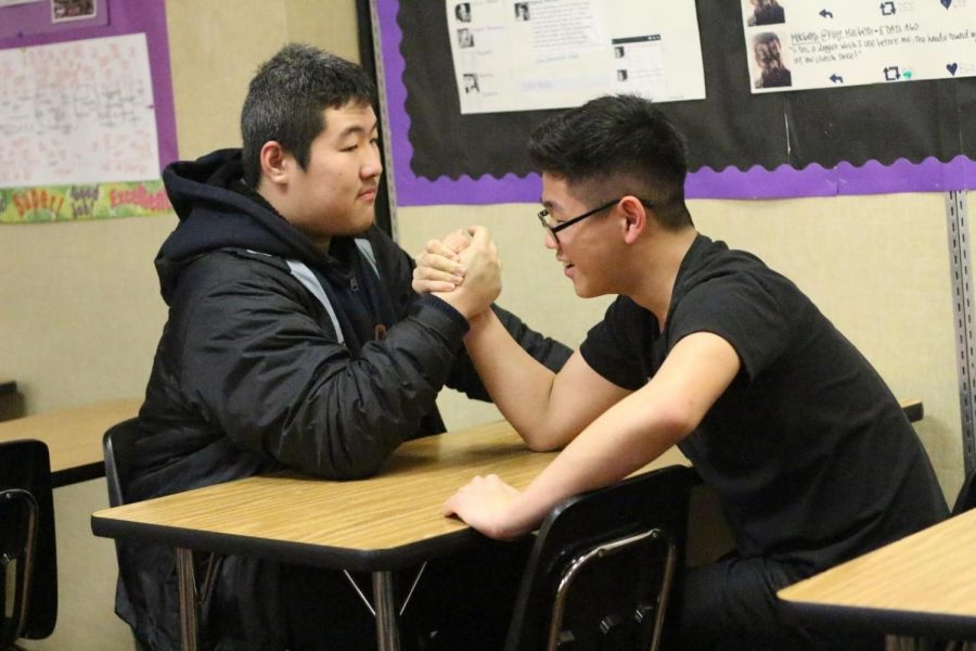 Junior Jack Che, left, and freshman Isaac Chung arm wrestle during lunch. The club meets every Wednesday to compete against each other.

