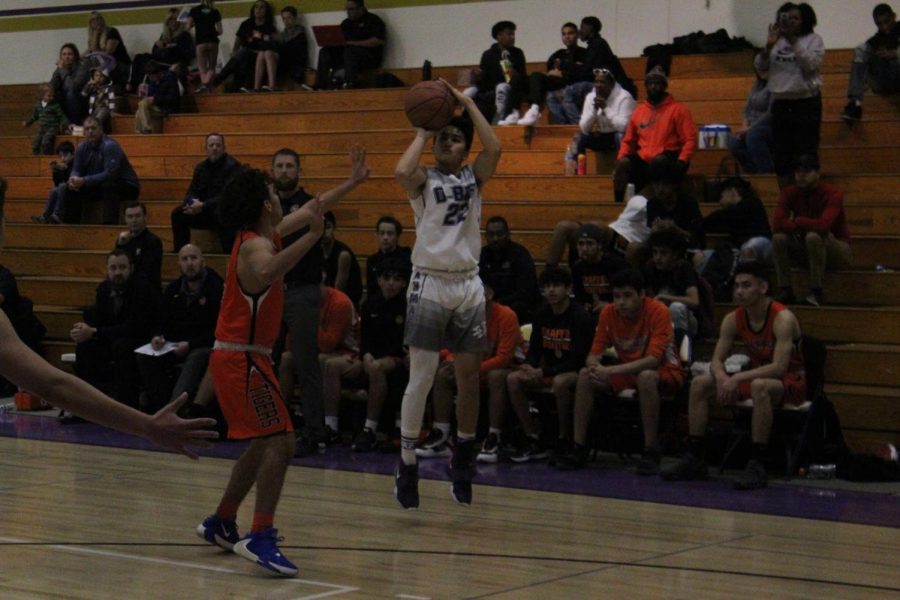 Senior Noah Del Campo fires up a three pointer in the win against Chaffey.